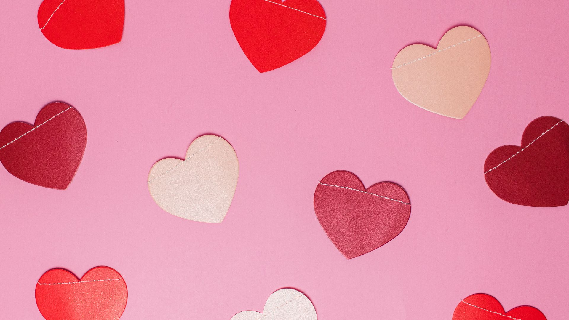 pink background with hearts in various shades of red