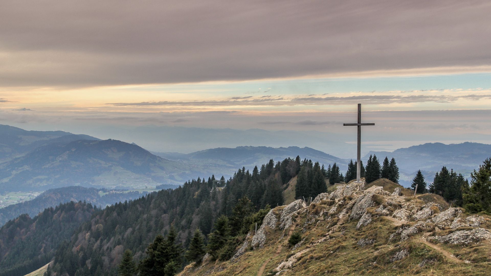 a picture of mountains and a cross 