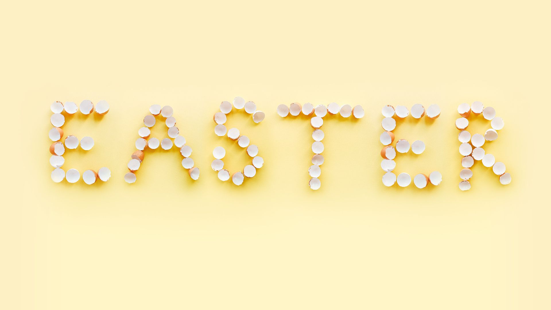 the word easter spelled out with egg shells