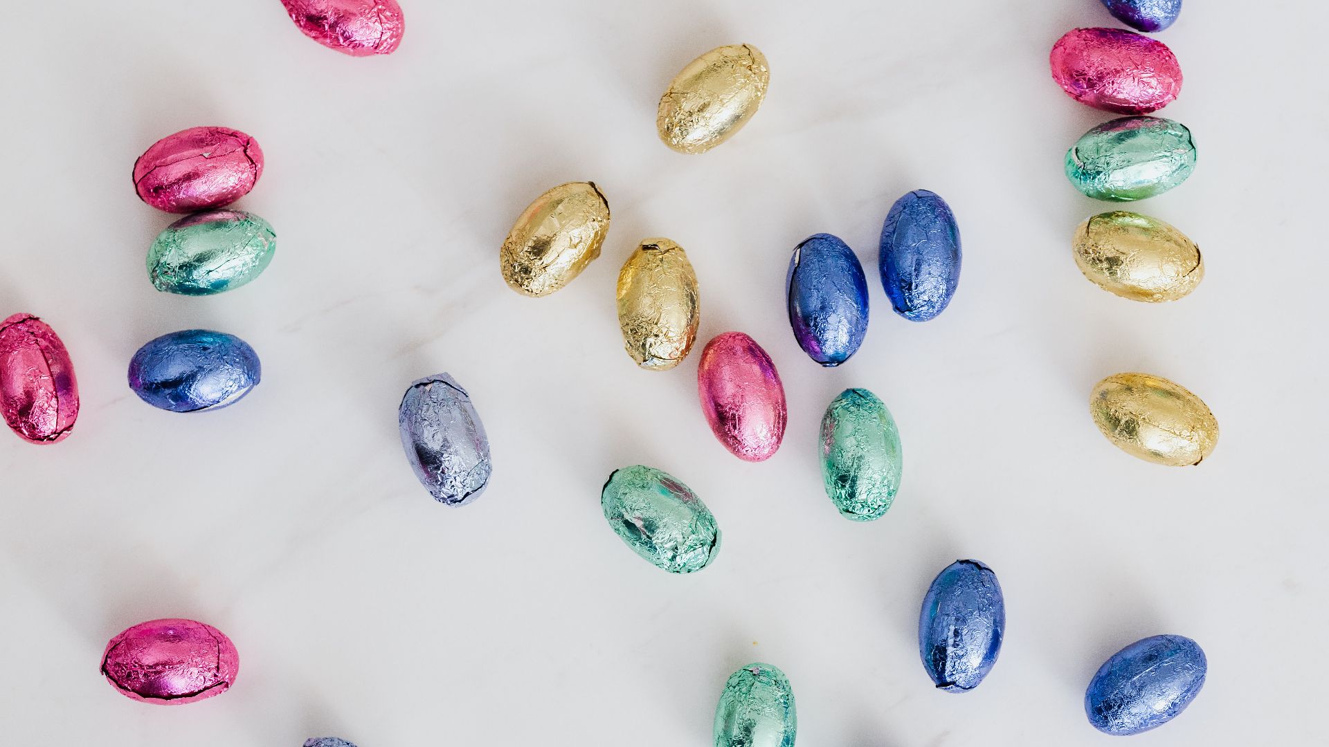 candy eggs with yellow, blue, and pink wrapping paper